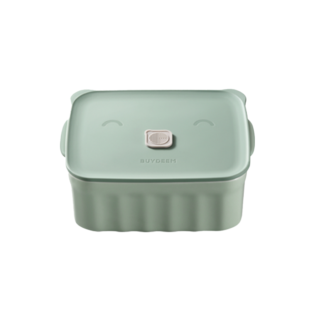 A green ceramic bento container with a happy face design on the lid.